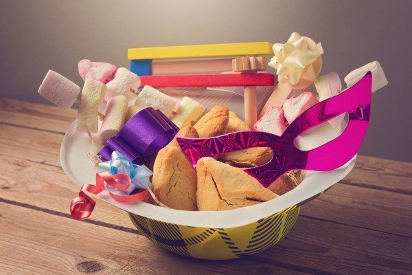 Purim holiday gifts with hamantaschen cookies and candy